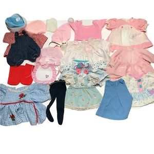Assorted vintage doll clothes plus the case